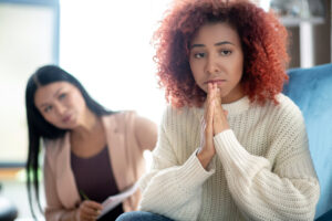 worried woman talking with her counselor indoors utc