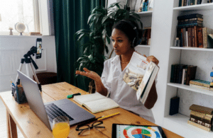 Online teacher holding textbook