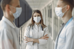 Nurse and doctors standing in hallway