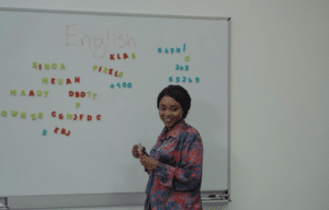 Teacher standing in front of write board
