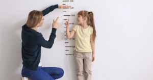 Teacher measuring student height