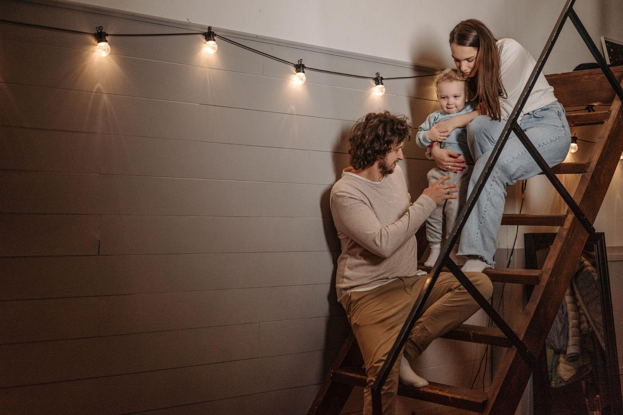 Family sitting together on an indoor staircase